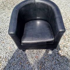 Black leather tub chair with black legs