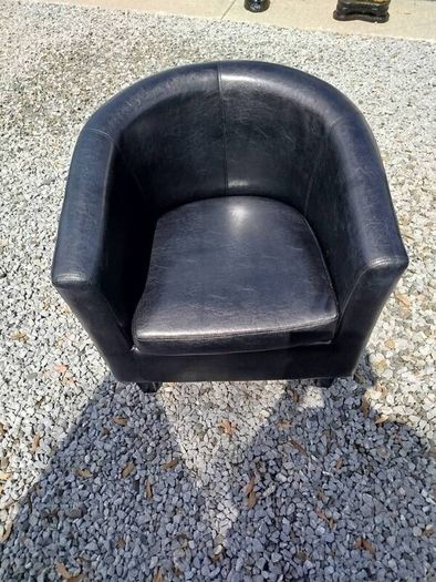Black leather tub chair with black legs