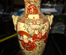 Japanese Satsuma vase featuring intricate hand painted designs of figures and patterns.  This type of earthenware pottery often dates to the Meiji period late 19th century or early 20th century