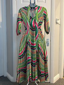 Brand new dress still with tag. Free size , will fit up to size 12