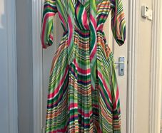 Brand new dress still with tag. Free size , will fit up to size 12