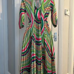 Brand new dress still with tag. Free size , will fit up to size 12
