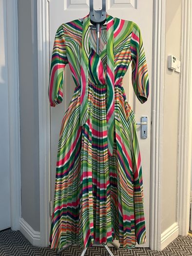 Brand new dress still with tag. Free size , will fit up to size 12