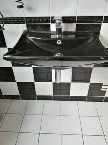 Unusual black bathroom sink with free tap