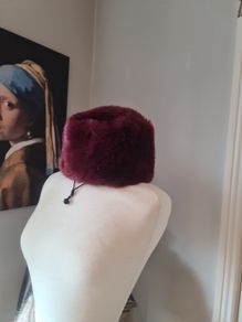 fur effect hat. wine in colour