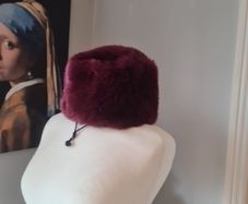 fur effect hat. wine in colour