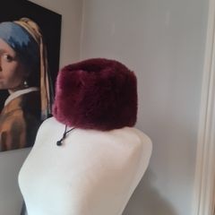 fur effect hat. wine in colour