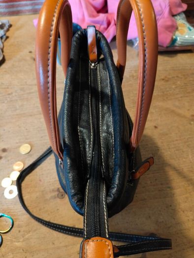 David Jones  is a classic, two-tone black pebbled Faux leather bucket bag.