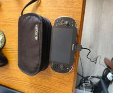 PS Vita with case, charger and 2 memory cards