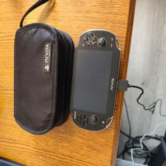 PS Vita with case, charger and 2 memory cards