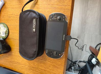 PS Vita with case, charger and 2 memory cards