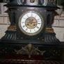 Victorian French Black Slate Mantle Clock (Very large and heavy) with bronze ornamentation Oversized. Open escarpment slate plate Roman numerals. Circa 1890s. Accented with Trojan head. Flanked by two Hellenistic ladies heads on sides. Rose cartouche mask Image 4
