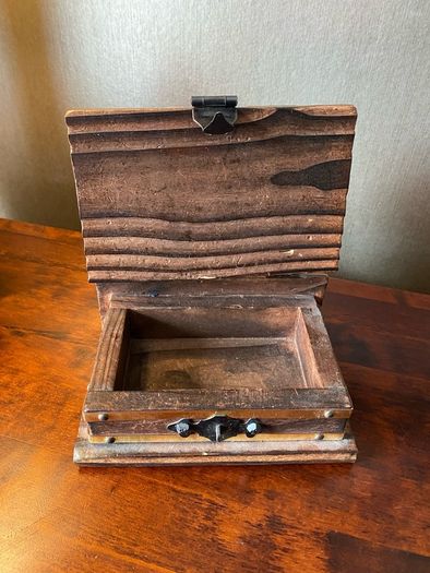 antique A wooden box in the form of a book, having brass escutcheon and black metal hinges. 18 x 15cm.