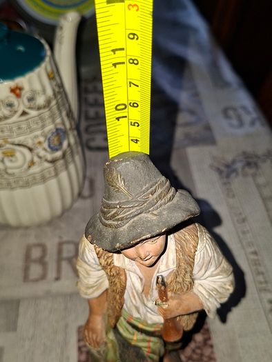 Old Painted Terracotta of a Young Country Boy Holding a Flute, standing on a rocky base. It resembles late 19th- or early 20th-century European decorative sculptures, such as pieces produced by makers like Goldscheider