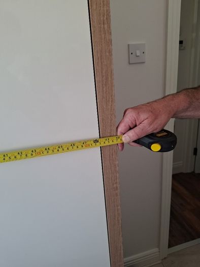 Timer and white wardrobe and bedside locker