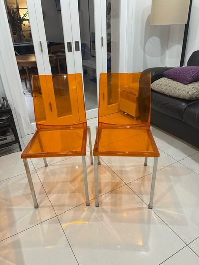 Four striking chrome and plastic orange vintage Italian dining chairs. Very decent and useable condition. A bargain at this price.