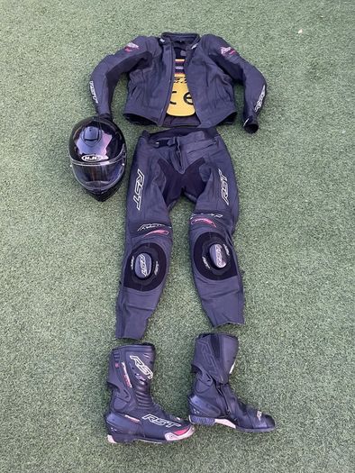 Motor cycle racing leathers with boots, gloves and helmet.