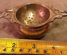 white metal tea strainer