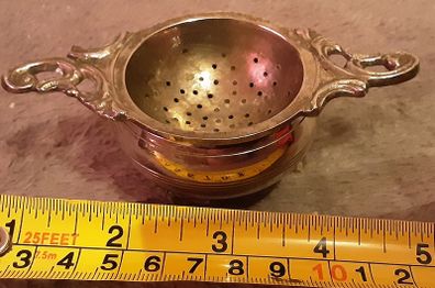 white metal tea strainer