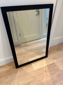 Black framed bevelled mirror