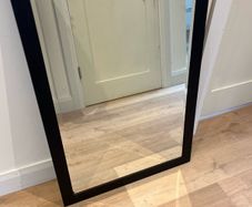 Black framed bevelled mirror