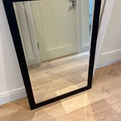 Black framed bevelled mirror