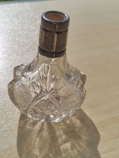 Vintage crystal bottle with silver top
