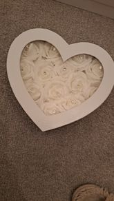 White heart-shaped box with faux flowers