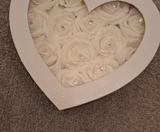 White heart-shaped box with faux flowers