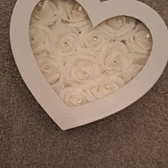 White heart-shaped box with faux flowers