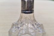 Vintage crystal bottle with silver top