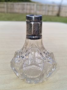 Vintage crystal bottle with silver top