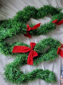 Green Christmas garland with red bows 2,5m