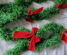 Green Christmas garland with red bows 2,5m