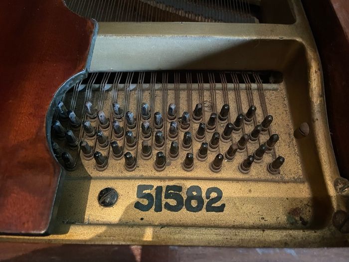 a circa-1931 Monington & Weston baby grand with matching stool.
