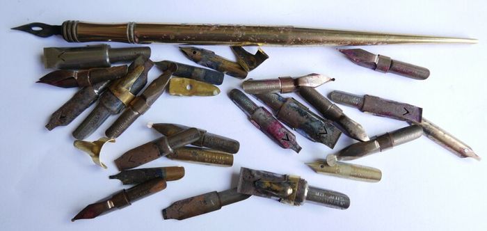 Vintage dip pen with collection of assorted nibs