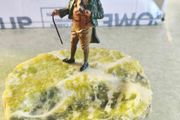 A gentleman holding a walking stick, mounted on what appears to be an onyx or serpentine stone base as ashtray or pine holder.Royal Doulton Figure "Owd Willum . Designed by L Harradine it was issued between 1949 and 1973.