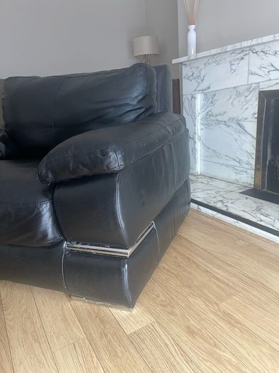 black Leather Armchair featuring plush pillow top arms and chrome accent feet need gone ASAP due to house clearance