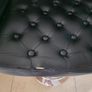 2 black faux leather bar stools with padded seats, armrests and chrome bases. Image 4