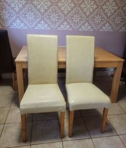 2 cream leather chairs