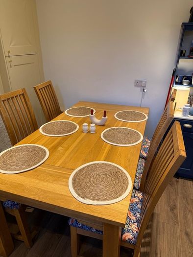 Solid oak dining table & 6 reupholstered dining chairs