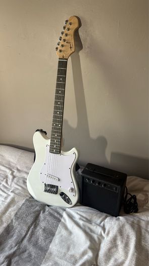 White electric guitar with amp box used only twice