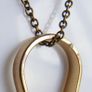 Vintage necklace features a polished, knocker-shaped pendant  gold plated, centered with an iridescent turquoise Spinning Fob Image 5