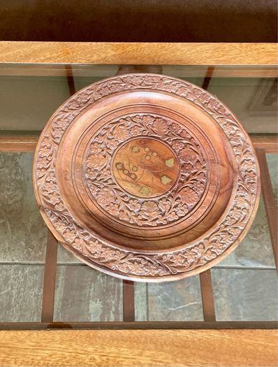 Beautiful vintage hand-carved wooden tray featuring an intricate floral border and a decorative brass inlay geometric star motif in the centre. The craftsmanship is detailed and very tactile, giving this piece a rich, warm character. The tray is solid and