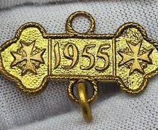 Some sort of gold color medal 1955