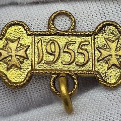 Some sort of gold color medal 1955