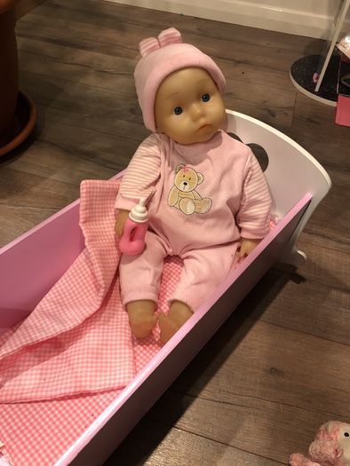 Doll crib with a baby