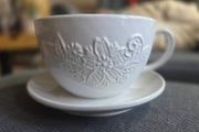 plant pot in the shape of a cup and saucer.