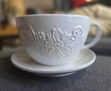 plant pot in the shape of a cup and saucer.