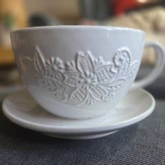 plant pot in the shape of a cup and saucer.